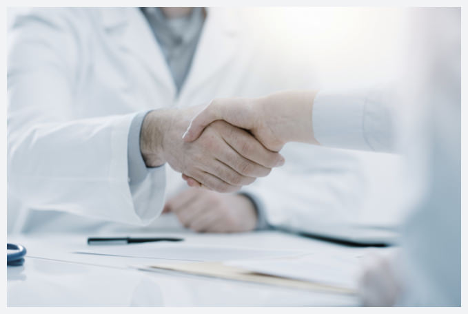 Image of doctor shanking hands with patient